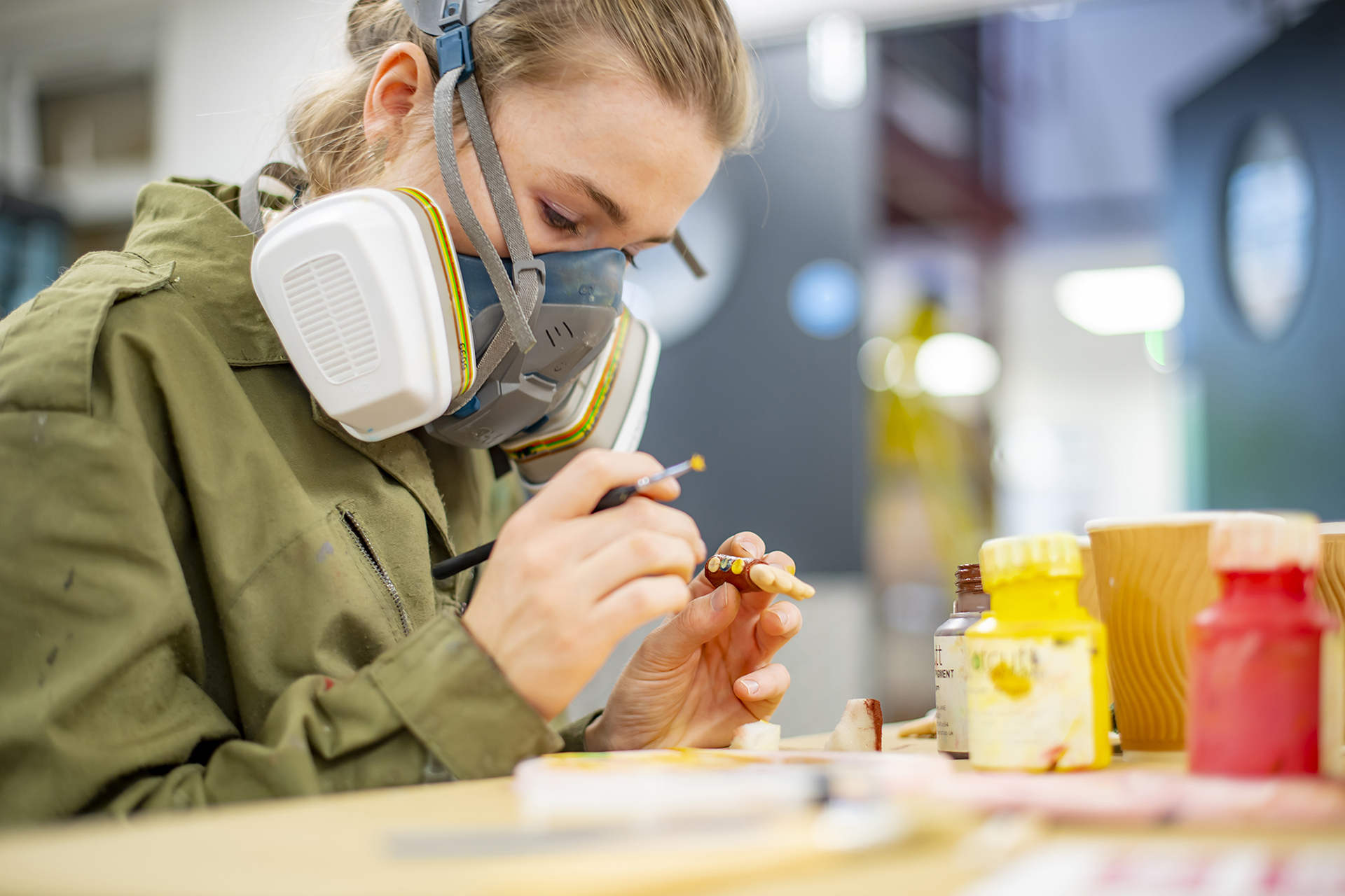 Student painting model puppet hand