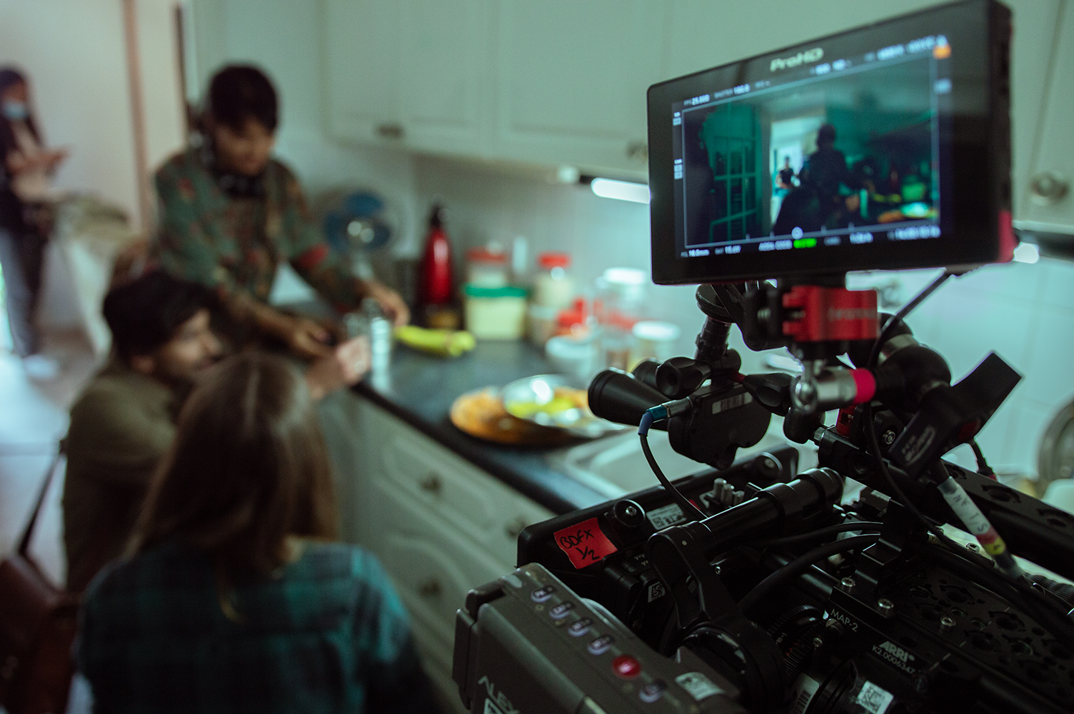 people on film set with camera
